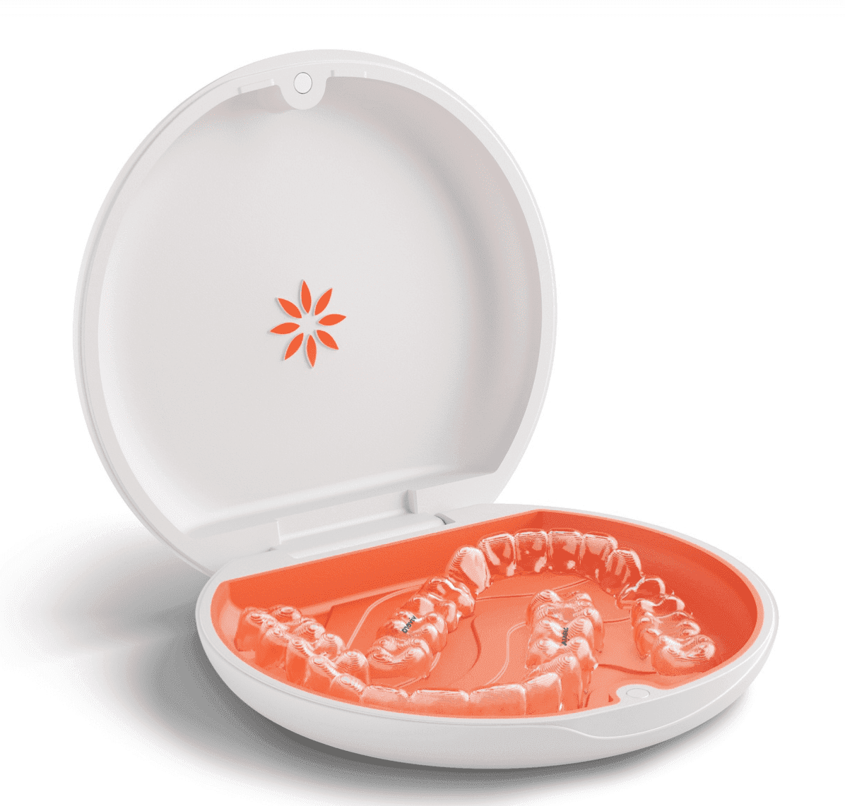 Clear dental aligners placed in an open round orange case with a white lid.